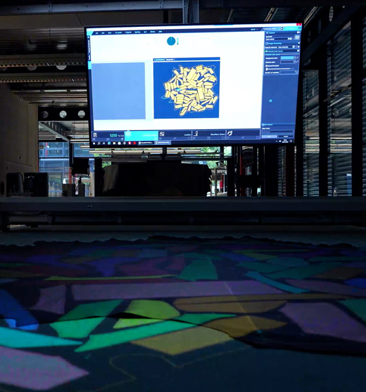 Nested Mindhive FinishSelect™ digital defect map projected onto finished leather, showing color-coded cutting zones for optimized yield